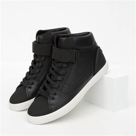 black high top designer sneakers.